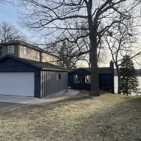 Finished Hail Navy cedar shake exterior and white garage door at a Fish Lake home in Maple Grove, MN