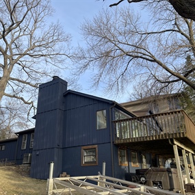 Finished Hail Navy cedar shake exterior and white garage door at a Fish Lake home in Maple Grove, MN