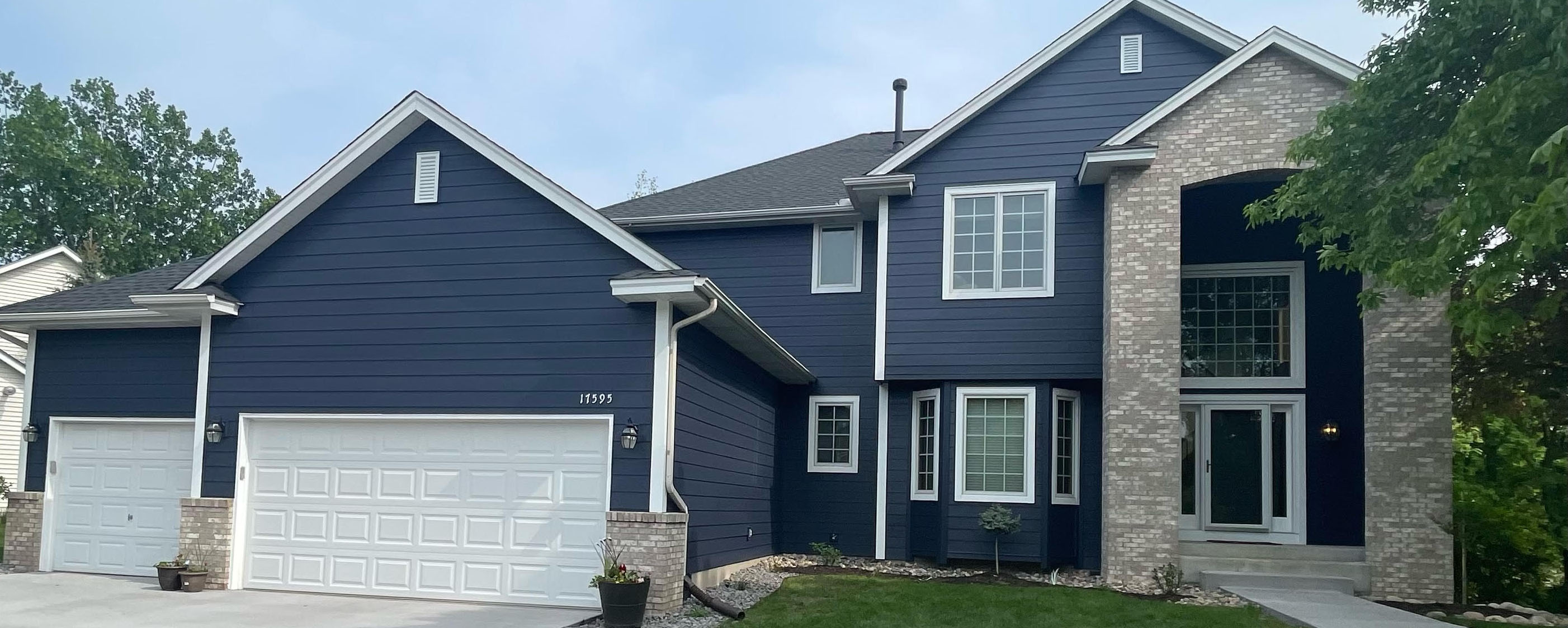 Exterior house painting with navy blue siding